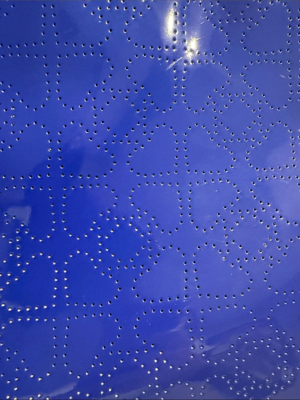 Kate Spade heart perforated patent leather crossbody in cobalt blue.